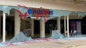 Barclays bank branches across the UK have been hit by protests, with red paint and graffiti marking buildings. Activists demand divestment from Israel's weapons trade and fossil fuels, sparking widespread damage and arrests.